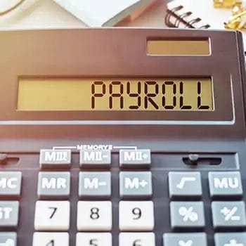 Payroll written on a calculator