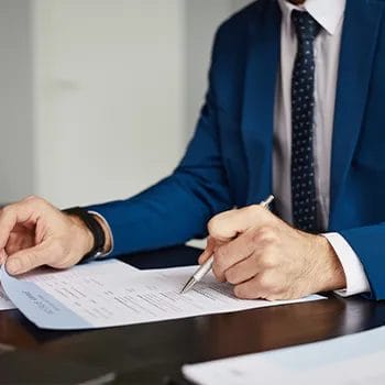 hand view of a man writing on a paper