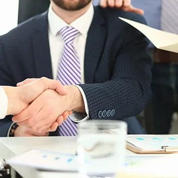 A busy man shaking hands with another person
