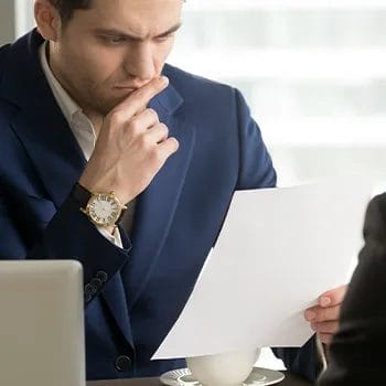 Man staring seriously on a legal paper