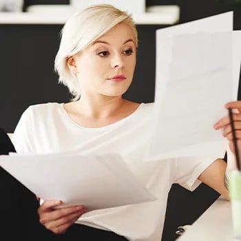 Woman comparing two different files