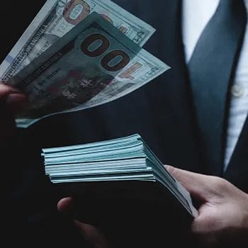A man in business suit counting money