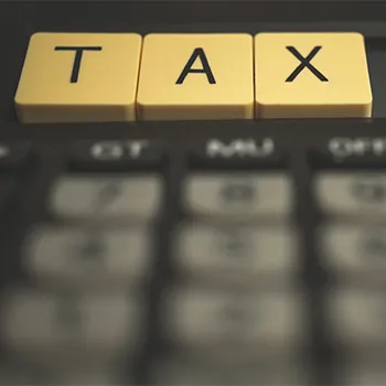 Close up image of a calculator with TAX word