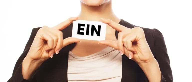 A woman showing an EIN number for an LLC