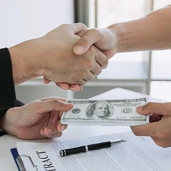 Shaking hands to an attorney while giving payment