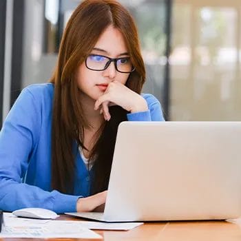 Woman in an office using her laptop