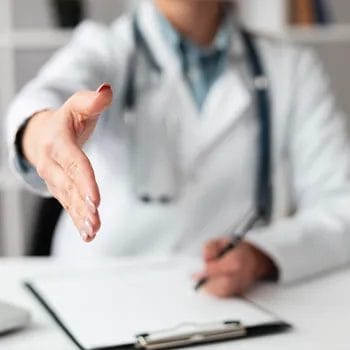 Doctor reaching out for patient's hand