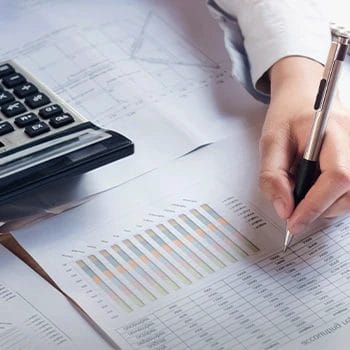 A graph to track taxes and a person calculating the papers