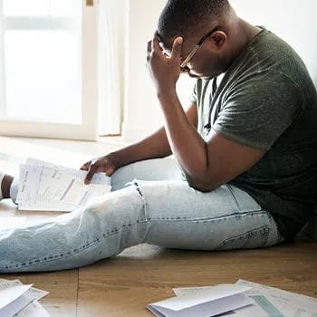 Problematic and stressed man holding debt files