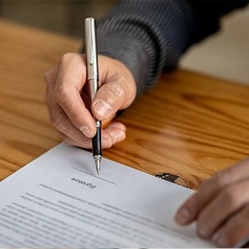 Holding a pen and is about to write signature the contract