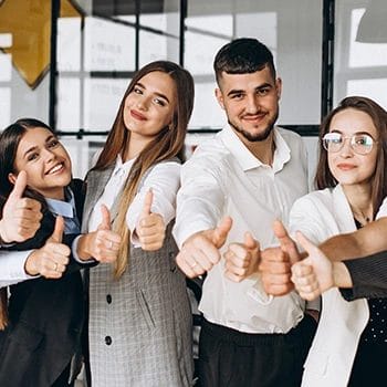 Members of an office giving a thumbs up