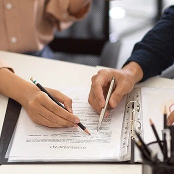 Both person pointing at the operating agreement document file