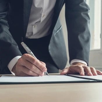 A man signing a paper for a South Dakota LLC