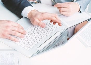 Two persons discussing the difference between registered agent to registered office
