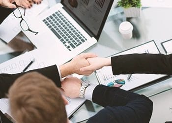 A group of employees arranging the documents after an LLC was dissolved