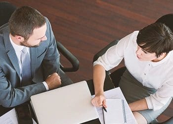 Two coworkers discussing