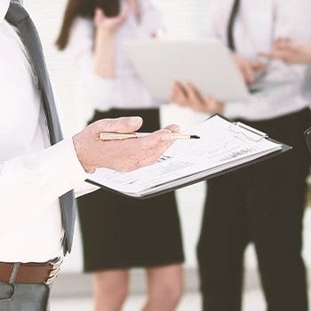 An office worker holding a clipboard