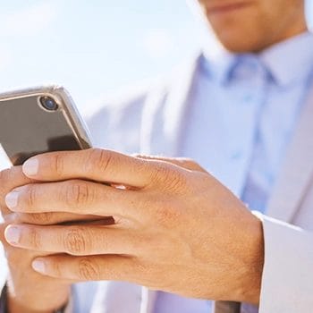 A person holding his phone outside