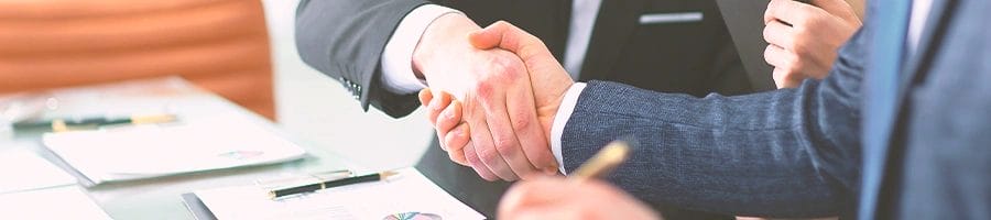 Two office workers shaking hands