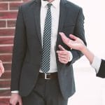 Professionals standing around while talking about best registered agent services