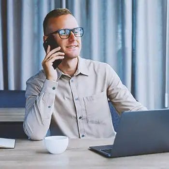 A South Dakota registered agent on the phone while in front of a laptop