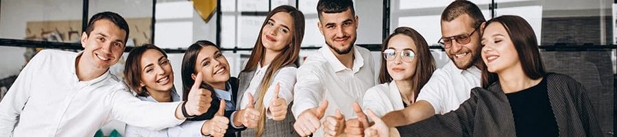 A group of people showing a thumbs up