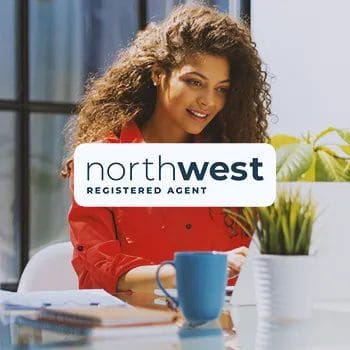 Northwest Registered Agent logo with a business woman doing work in the background