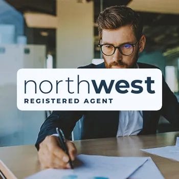 Northwest Registered Agent Service logo with a businessman signing paperwork in the background