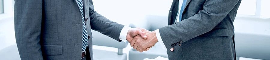Business men shaking hands and agreeing with the benefits of creating an LLC in Michigan