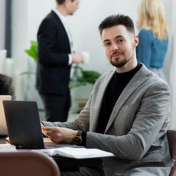 An image of a business man working in front of a laptop