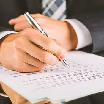 An office worker signing a document