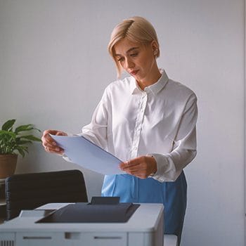 A person filing paperwork in an office