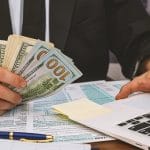 An LLC owner calculating the cost of an LLC in Wisconsin