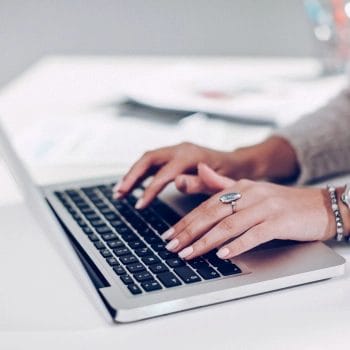 Hands on laptop showing how to change registered agent in Arizona