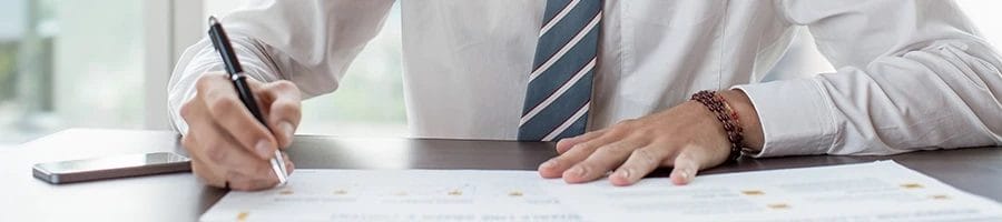 Serious businessman writing on a reservation form