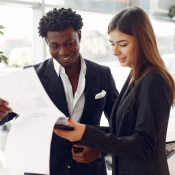 Two people looking at paper on how to change your Colorado registered agent